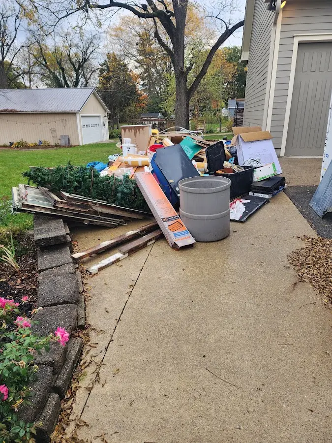 Dumpster being loaded with debris for 12 Yard Dumpster Rental in Warr Acres